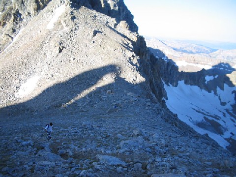 Jeff walking across a rocky mountain ridge.